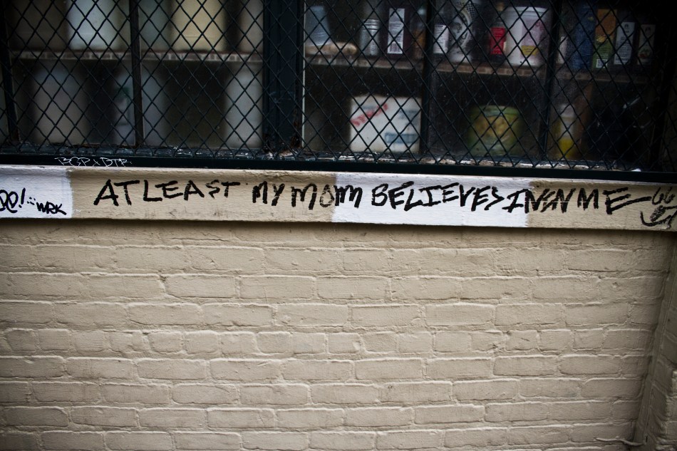 Graffiti in the French Quarter in New Orleans that reads "At last my mom believes in me"