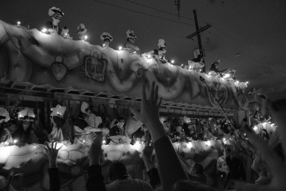 The Nyx Mardi Gras parade in Uptwn New Orleans, LA on February 6, 2013. Revelers reach for beads as a float passes by.