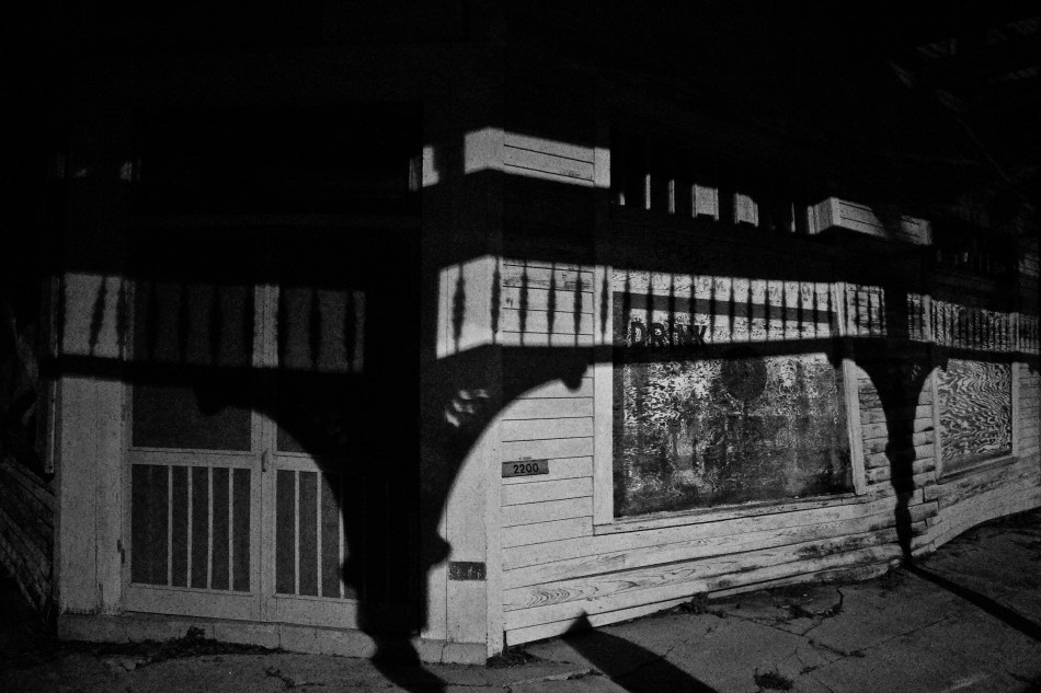 An old storefront on a street corner at night in New Orleans, LA
