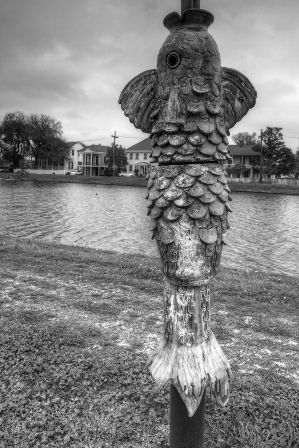 A sculpture of fish mounted on a parking sign in the Bayou St. John neighborhood of New Orleans