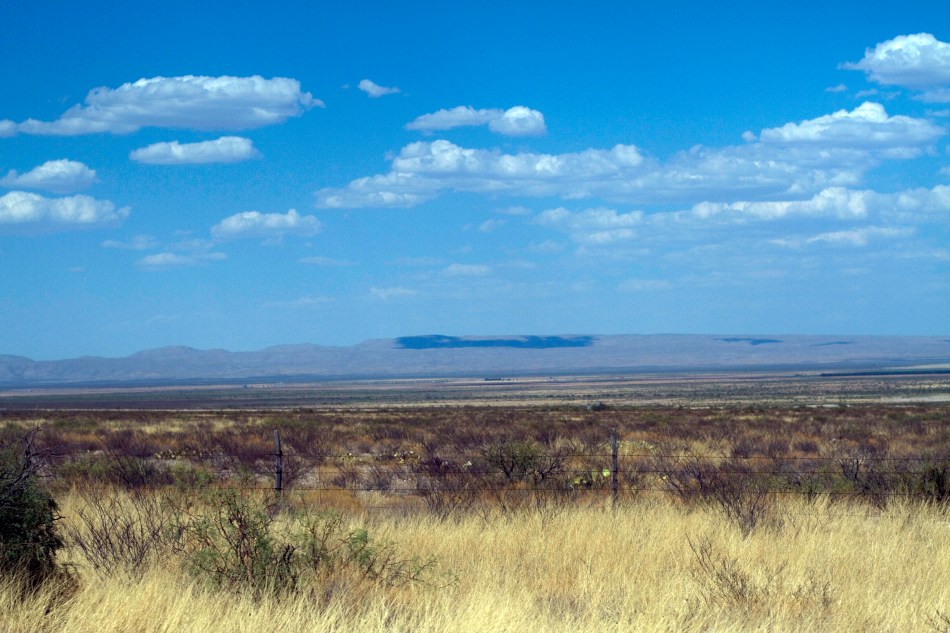 A shadow of a cloud hanging over the desert in the Southwestern U.S.