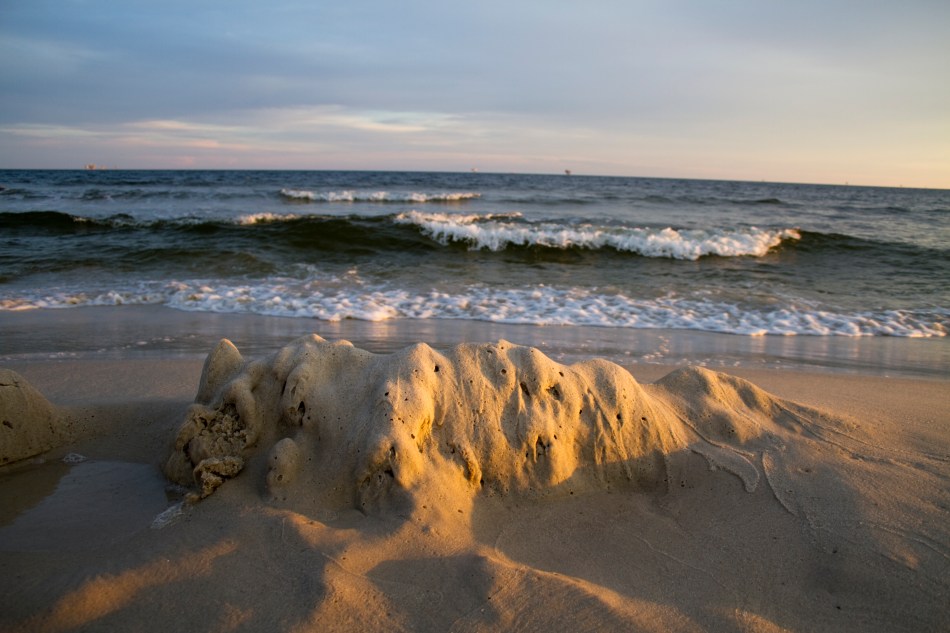 A mound of sand and the gulf of mexico