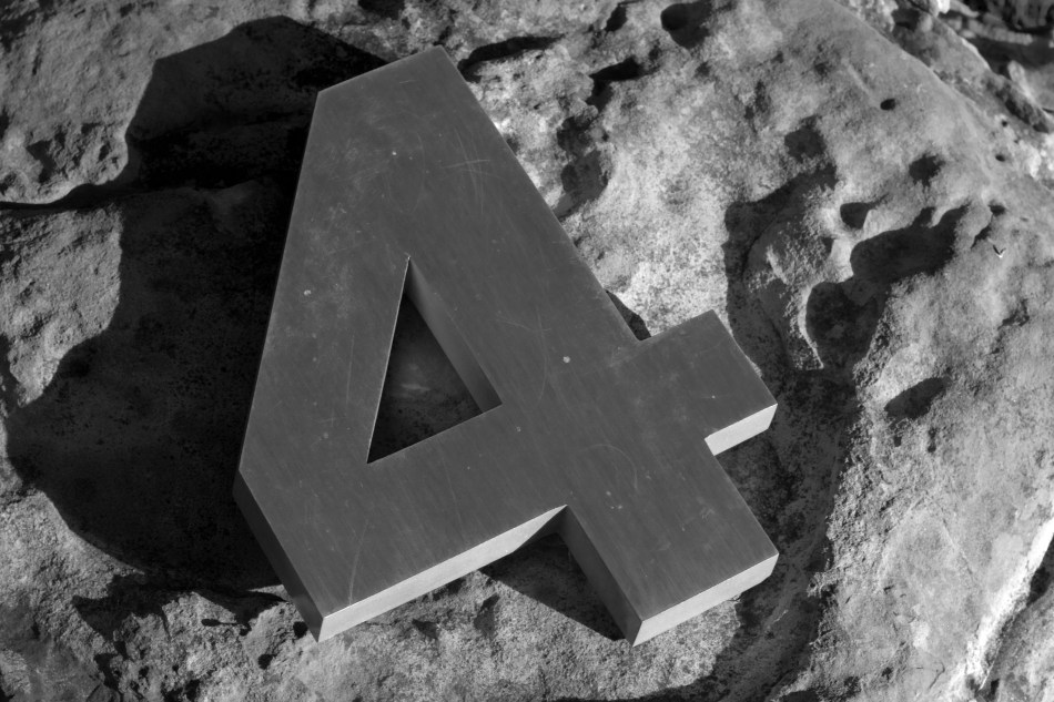 The number four on a rock.
