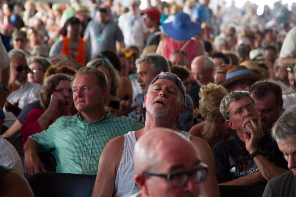 A man sleeps amongst the crowd inside the WWOZ/Zatarain's Jazz Tent at the New Orleans Jazz & Heritage Festival on April 26, 2014.