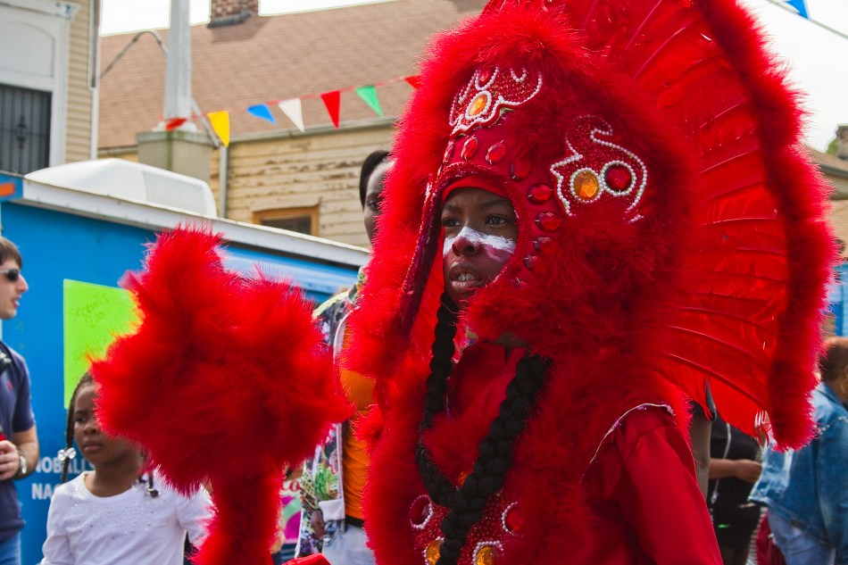 A Young Mardi Gras Indian dressed in full costume for the Super Sunday Celebration on March 15, 2015 in New Orleans, LA. Photo by Braden Piper bgpiperphotography.com