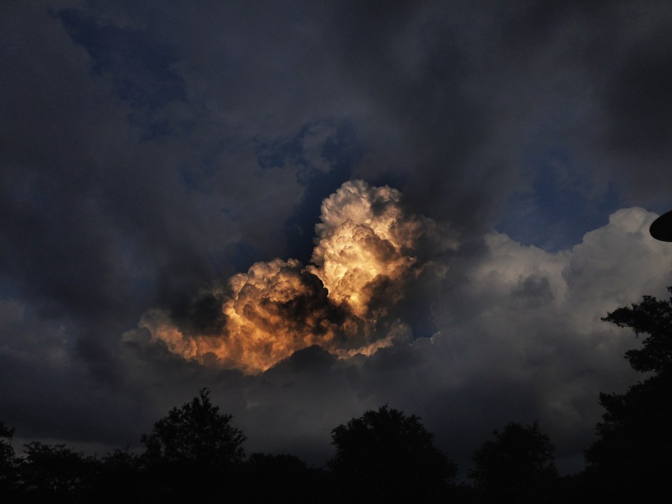 Sunlight illuminating a cloud in the sky creating a glowing effect